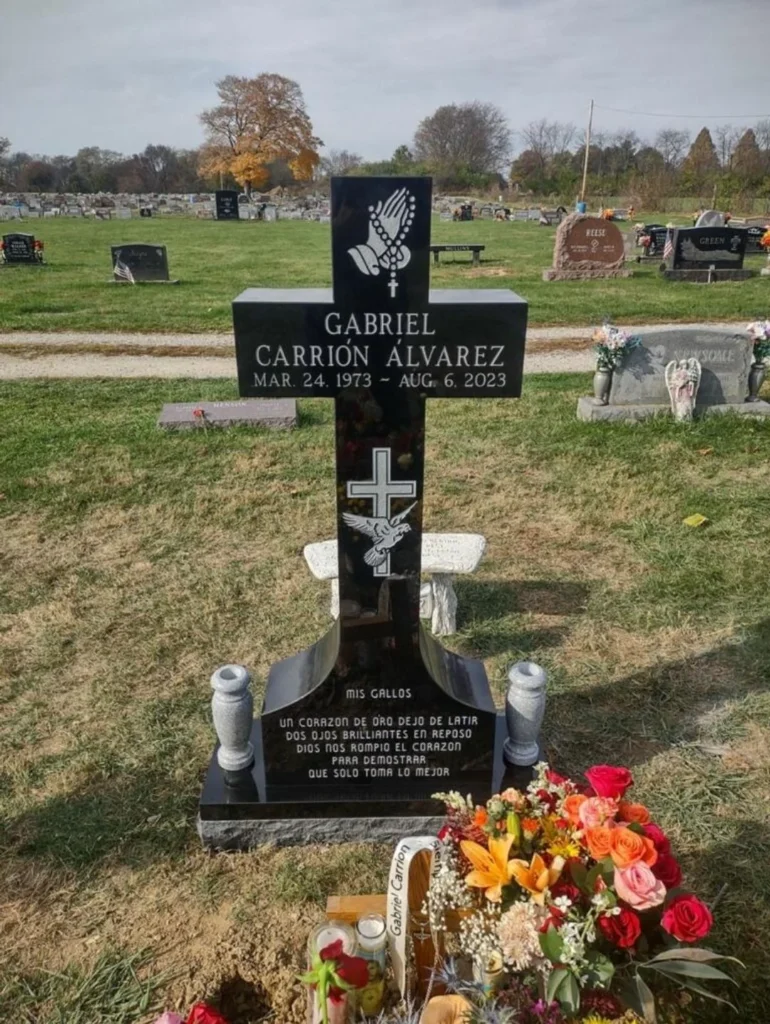 Single upright granite monument with polished front and carved family name, set in a peaceful cemetery.