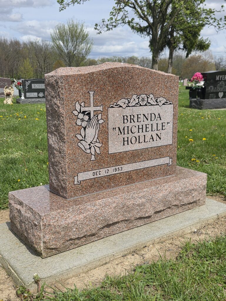 Elegant single upright monument headstone in polished granite with custom engraving at a memorial park.