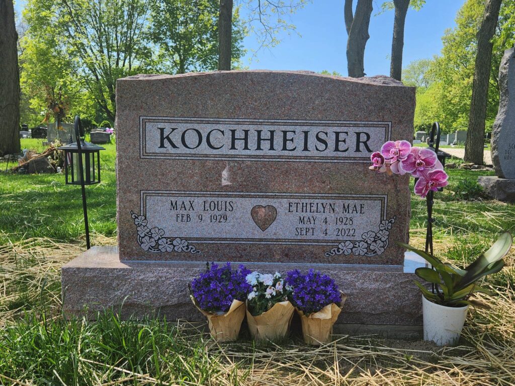 Companion upright monument headstone in polished granite with dual engravings and elegant detailing, symbolizing two lives remembered together.