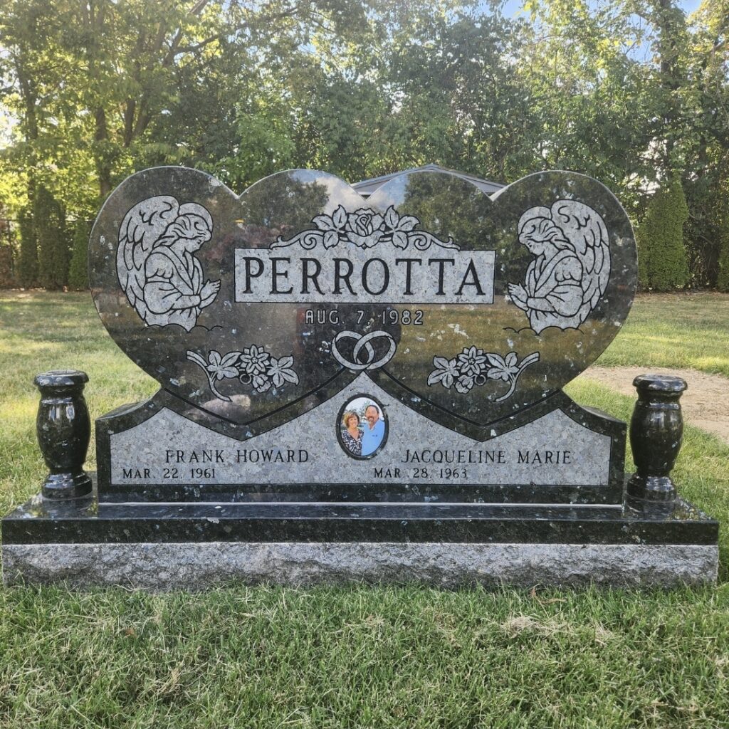 Companion upright monument in polished granite with dual engraving panels and decorative accents, honoring two loved ones side by side.