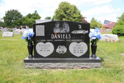 A traditional grey granite upright monument with a serpentine top, showcasing the standard of quality provided through our Funeral Home Partnership Program.
