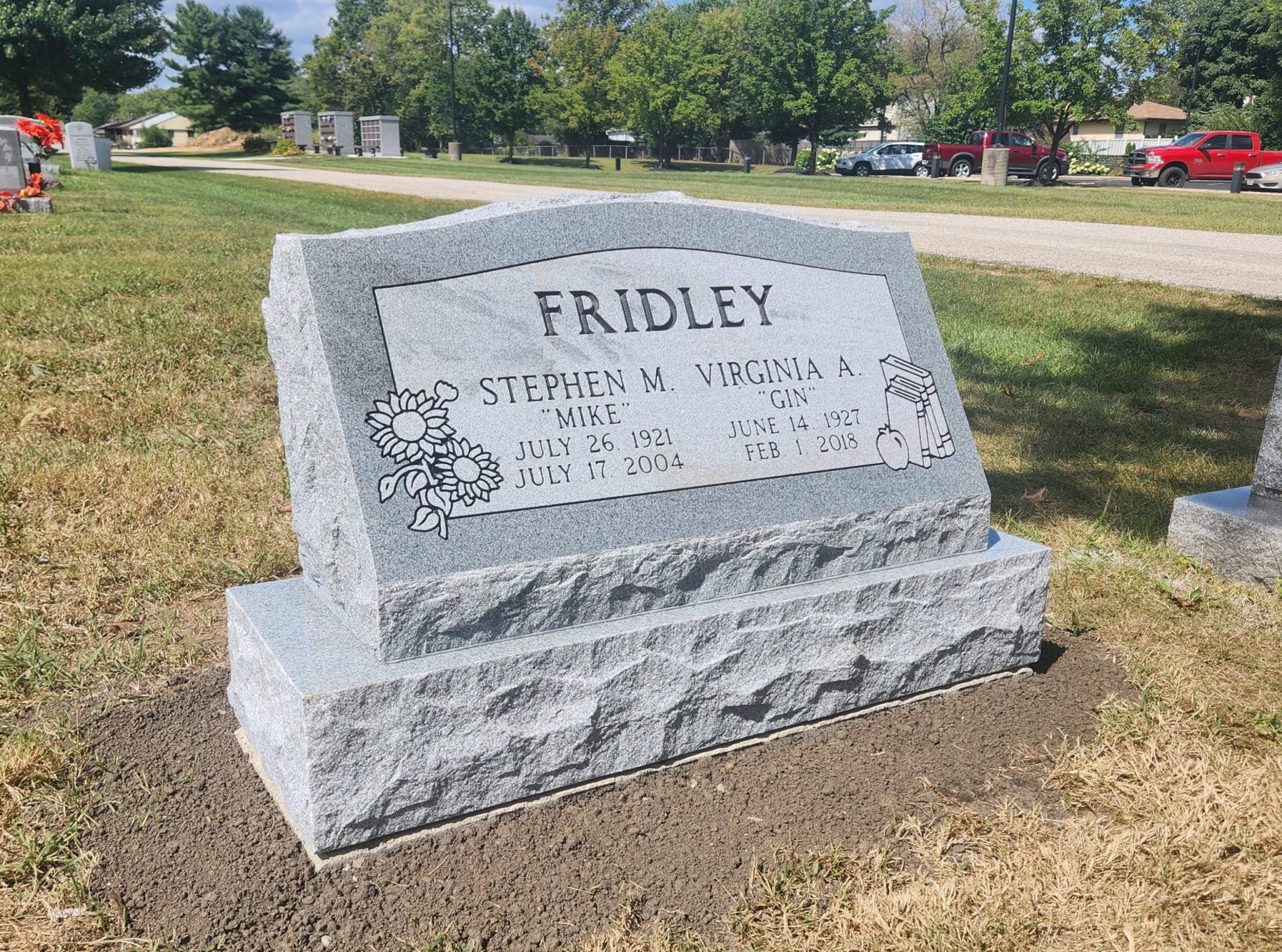 A custom granite slant marker with a rock-pitched edge and polished face, designed for a family memorial in Dublin, Ohio.