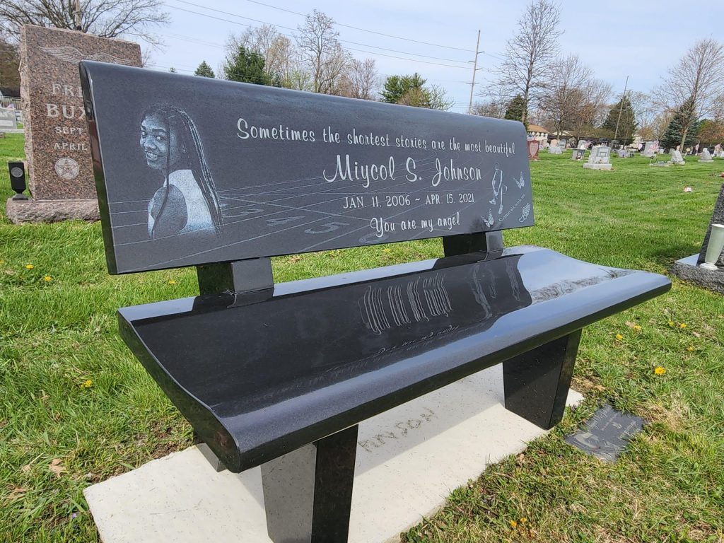 A custom granite memorial bench placed in a serene Addyston, Ohio setting, offering a peaceful place for reflection and honoring a loved one's memory.