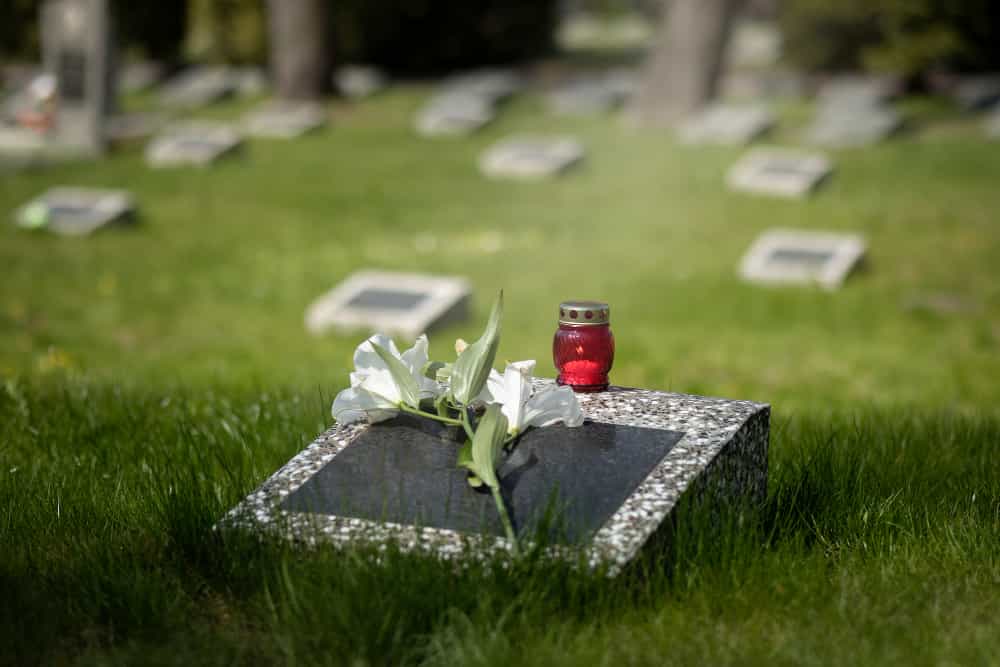 A dark granite single slant monument showing clear, readable inscriptions and a polished finish for an elegant cemetery tribute.