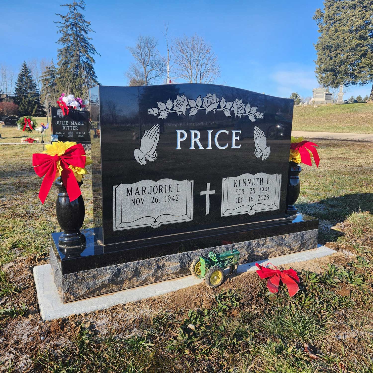 A dignified upright granite monument with a polished serpentine top and custom deep-relief engraving, standing securely on a concrete foundation in an Atlanta, Indiana cemetery.