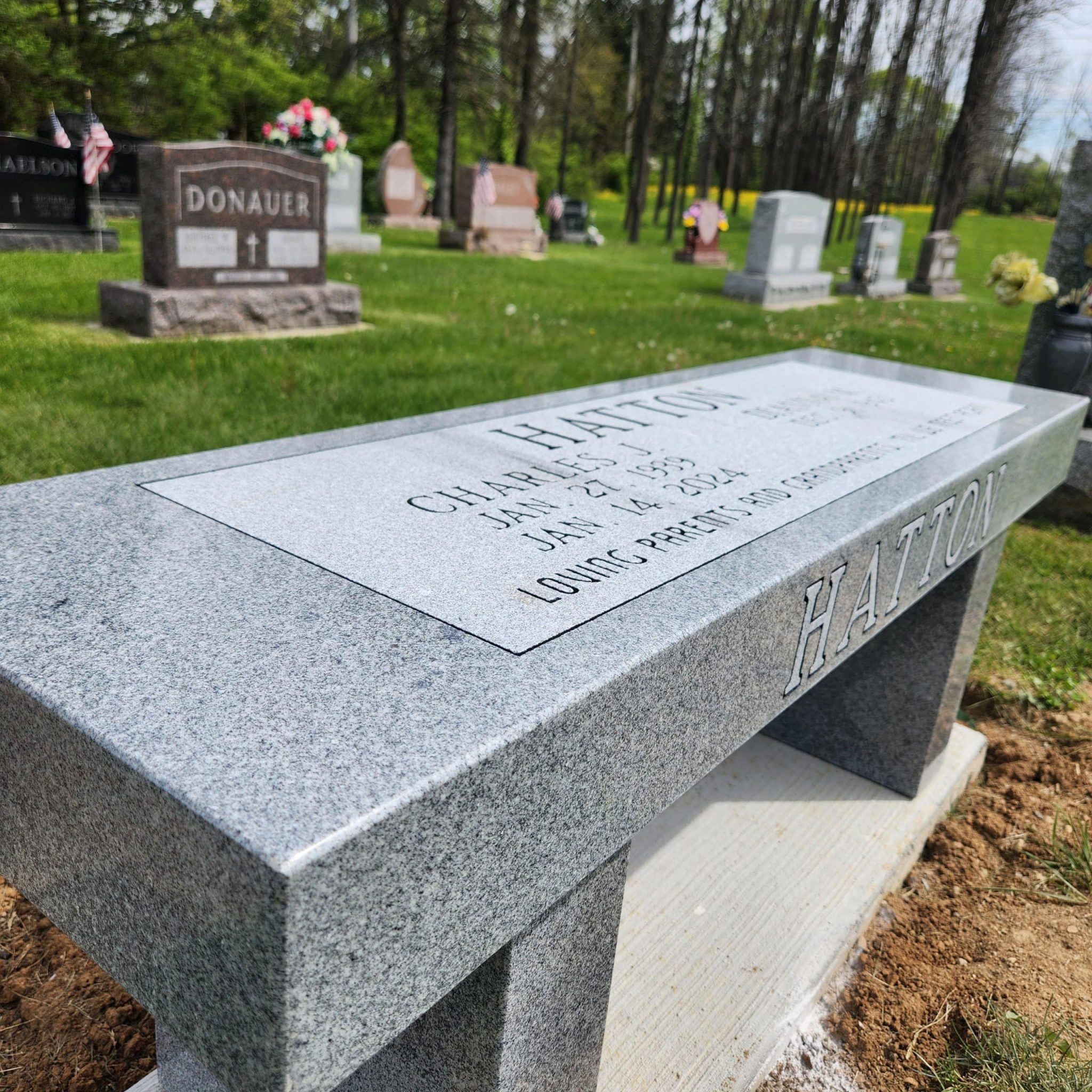 A custom-designed granite headstone installed for a family in Arcanum, Ohio, representing the expert stone carving and care provided by Stoltz Memorials.